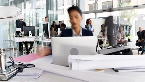 Time-lapse-of-businesswoman-having-coffee-while-working-at-desk