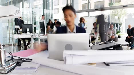 time-lapse of businesswoman having coffee while working at desk