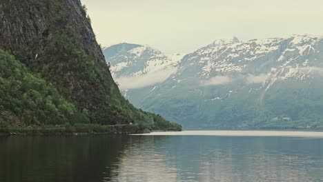 Beauty-of-lake-Eikesdalsvatnet-and-snowy-mountains-in-Norway,-low-angle-view