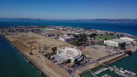 4k-Luftdrohnenansicht-Der-Treasure-Island-San-Francisco-Bay-Area,-Umgeben-Von-Türkisblauen-Meerwasserwellen,-Kamera-Bewegt-Sich-Zurück