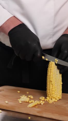 chef cutting corn on the cob