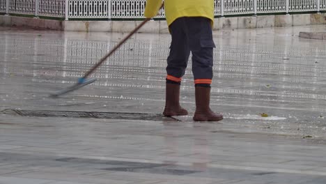 street sweeper cleaning wet pavement