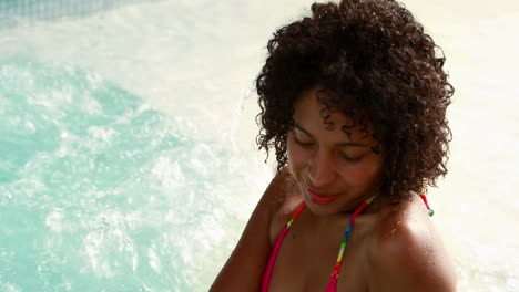 Gorgeous-woman-relaxing-in-hot-tub-and-smiling