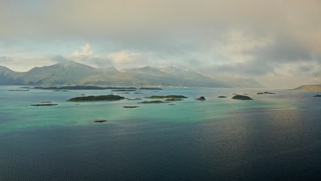 aerial drone shot over the island of senja in the lofoten ilsands, norway. high view of the vibrant turquoise sea and the small islands. breathtaking landscape, untouched natural wonder.