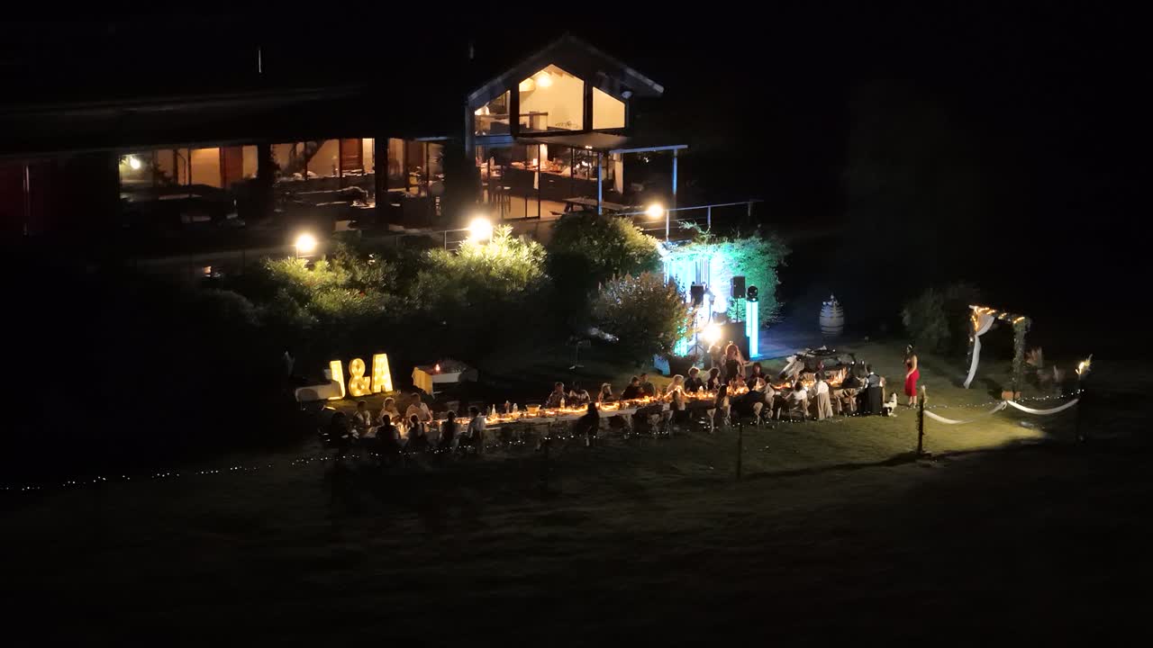 Aerial establishing shot of a wedding party eating a banquet outside