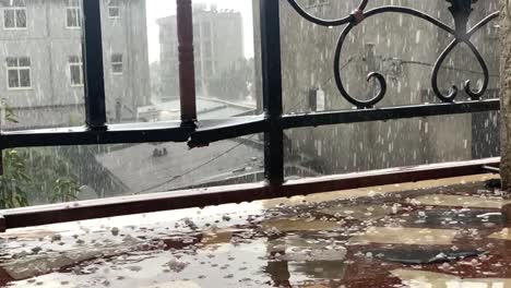 falling ice rain on the balcony rock with reflection and shatter on steel bar.