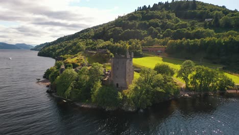 aerial pan of urquhart castle on loch ness in scottish highlands, scotland