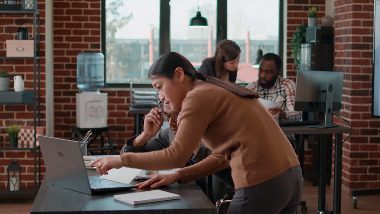 Man with disability doing teamwork with woman in office