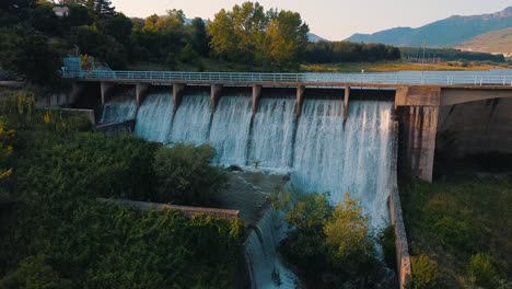 open floodgate of a dam letting the water flow through it