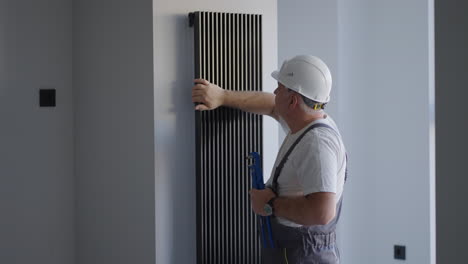 after the start of the heating season the plumber checks the warmth of the decorative battery in the house.