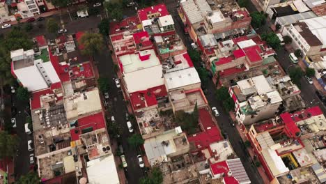 Red-rooftops-of-living-district-in-Mexico-city-with-narrow-streets,-aerial-view