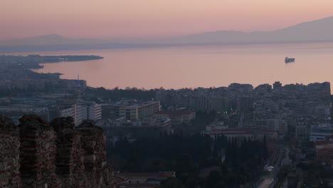 Panning shot of Thessaloniki from altitude with mount Olympus in the background