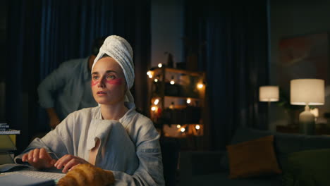 Busy-woman-working-distantly-at-dark-flat-closeup.-Focused-freelancer-texting