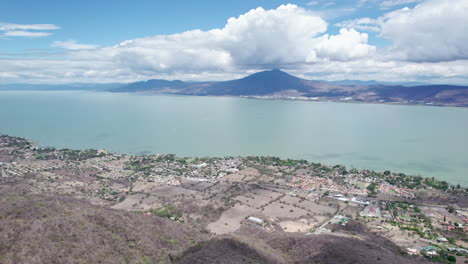 this compelling drone footage reveals a stunning aerial journey from the mountains to the vast, serene expanse of lake chapala in jalisco, mexico