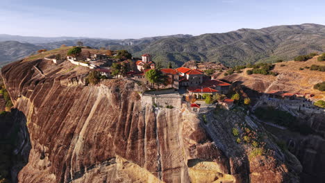 majestic aerial view of a historical greek monastery on a rocky cliff