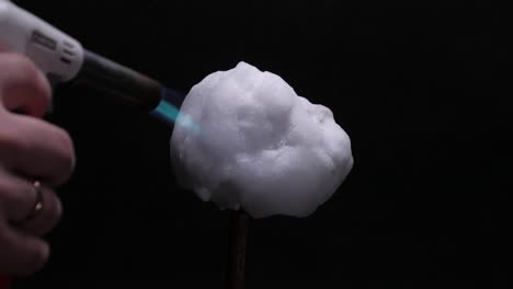 melting snowball with torch