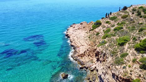 rocky peninsula of punta de la escaleta by mediterranean sea on a sunny day - seascape at benidorm, alicante, spain