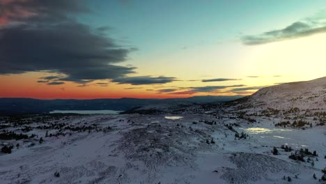 aerial over the snow covered land at dusk around blefjell mountain, telemark, norway