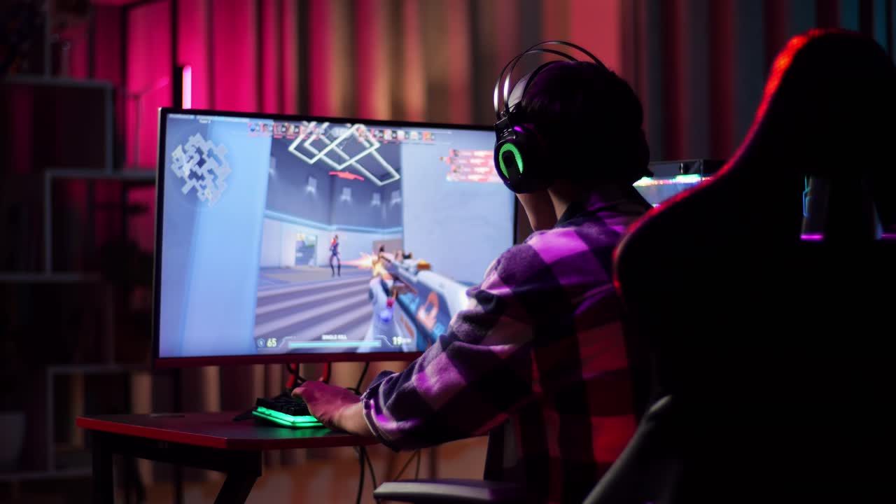 Excited Asian Teen Boy Gamer Celebrates Victory And Dancing  While Playing Video Game On Computer, Shooter Online Video Game