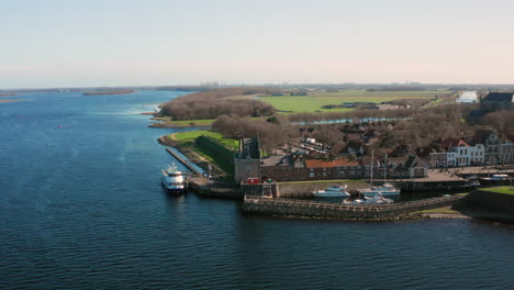 Aerial:-The-historical-town-of-Veere-with-an-old-harbour-and-churches,-on-a-spring-day