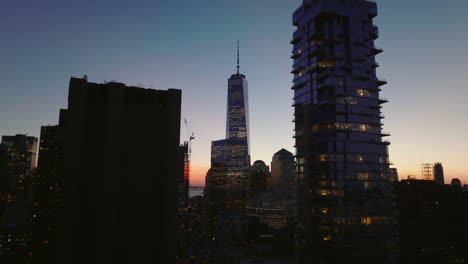 Forwards-fly-around-glass-tower-on-Leonard-street.-Revealing-modern-downtown-skyscrapers-in-Financial-district-against-colourful-sunset-sky.-Manhattan,-New-York-City,-USA