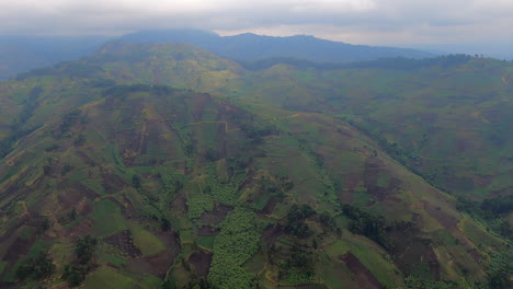 flyover steep hillsides full of small local crop fields in drc congo