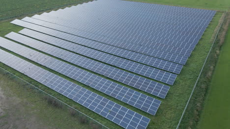 flying over and tilting down to long rows of solar panels