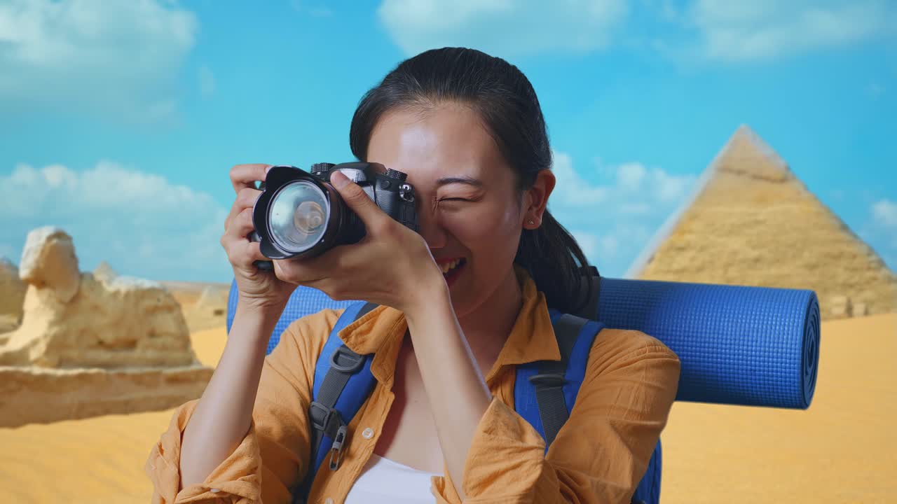 Woman taking a photo of the pyramids in Egypt