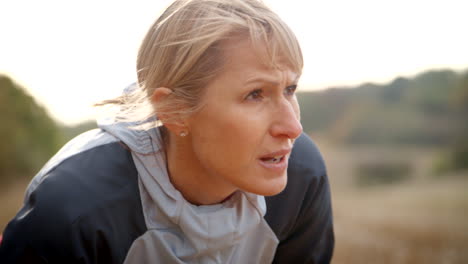 mature female runner resting during exercise in slow motion