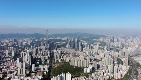 Hong-Kong-and-Shenzhen-border-line-over-Hong-Kong-rural-houses-with-Shenhzen-skyline-in-the-horizon,-Aerial-view