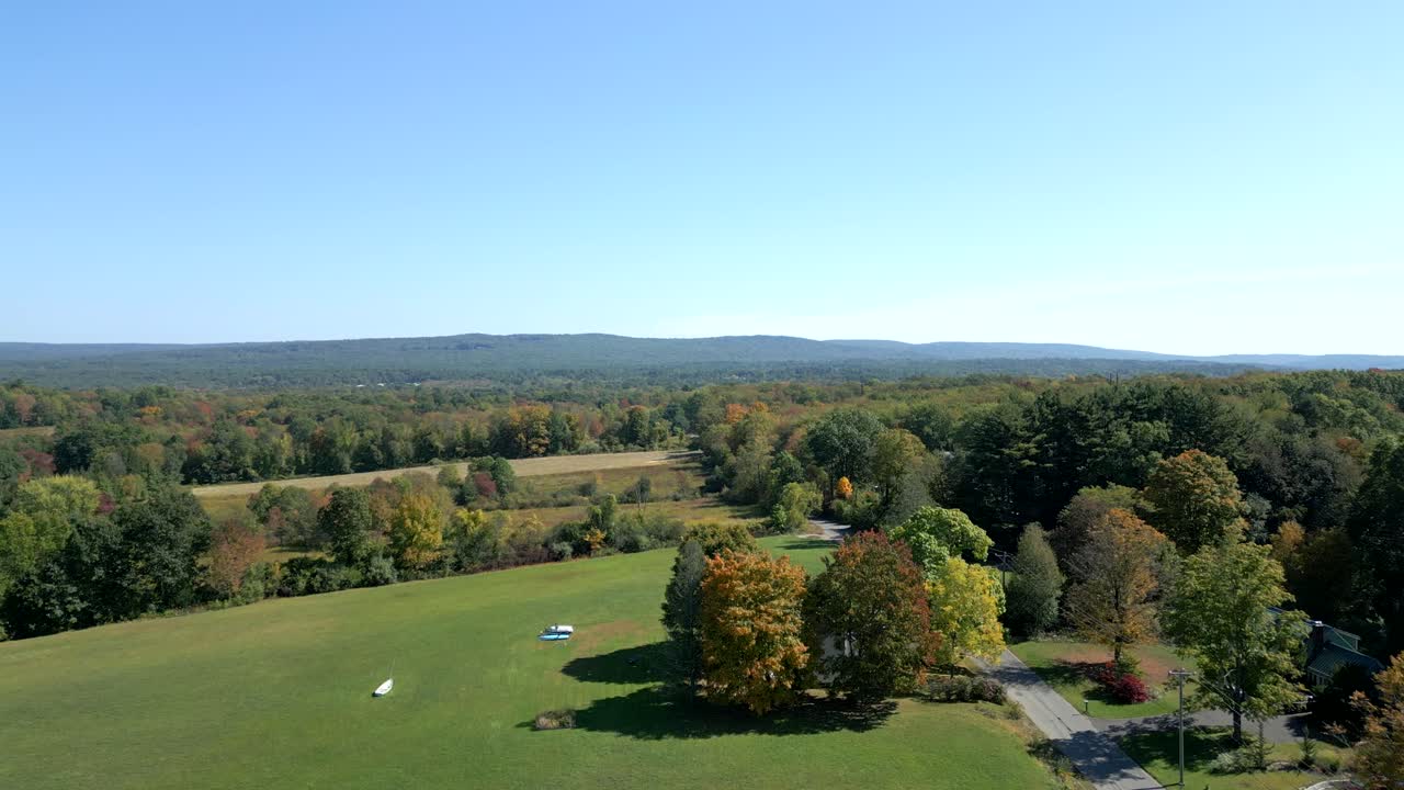 Sunny autumn view over fields and early fall trees in the countryside Amherst Groff Park, Massachusetts, USA