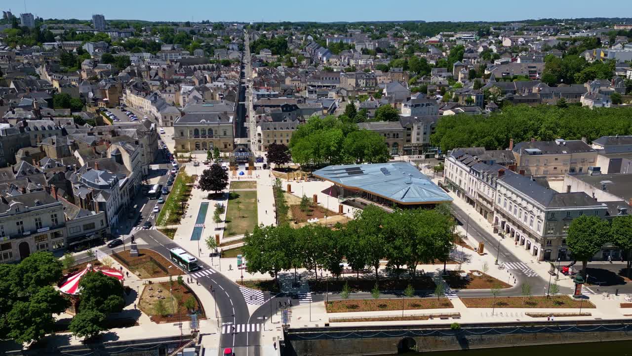 Elevated drone footage of 11 Novembre Square in Laval, showing new hall, river, skyline, carousel, historic city and cityscape