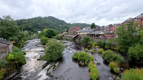 a picturesque river flowing through llangollen, wales