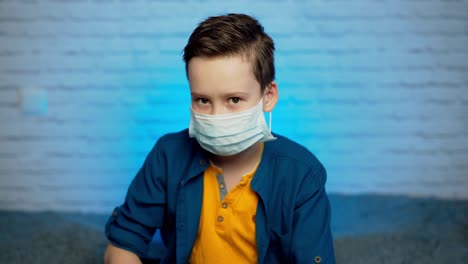teenage boy wearing medical mask to protect from infection of viruses, pandemic, air pollution, hazardous particles. stop coronavirus.