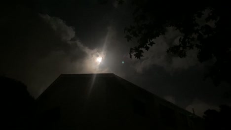 bright full moon in the evening in new zealand cloudy