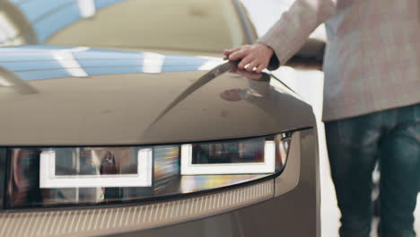 person looking at a new electric car in showroom