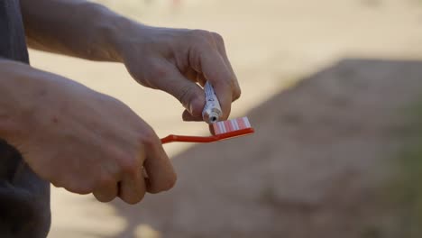 Washing-teeth-outside-with-toothpaste