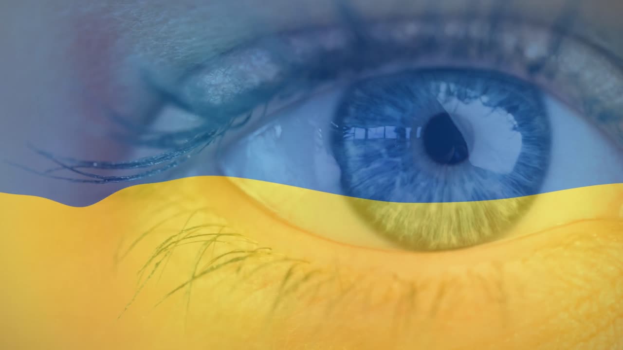 Animation of flag of ukraine waving over open eye of caucasisan woman