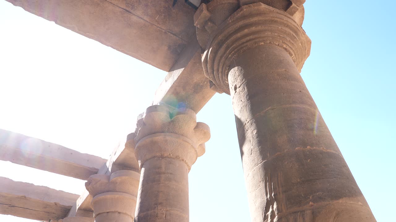 Panning shot of Ancient egyptian temple columns on a sunny day