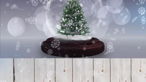 Animation-of-snow-falling-and-glowing-spots-over-snow-globe-with-tree-on-white-background