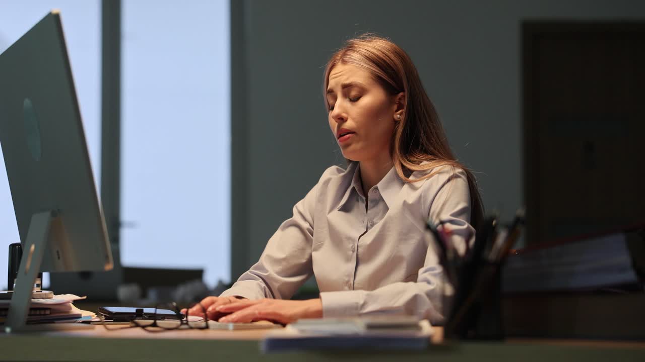 Woman Working Late at Night in an Office
