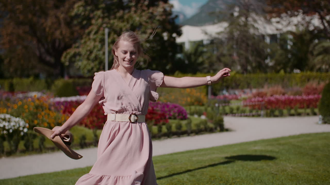 Woman Walking In Beautiful Blooming Flower Park