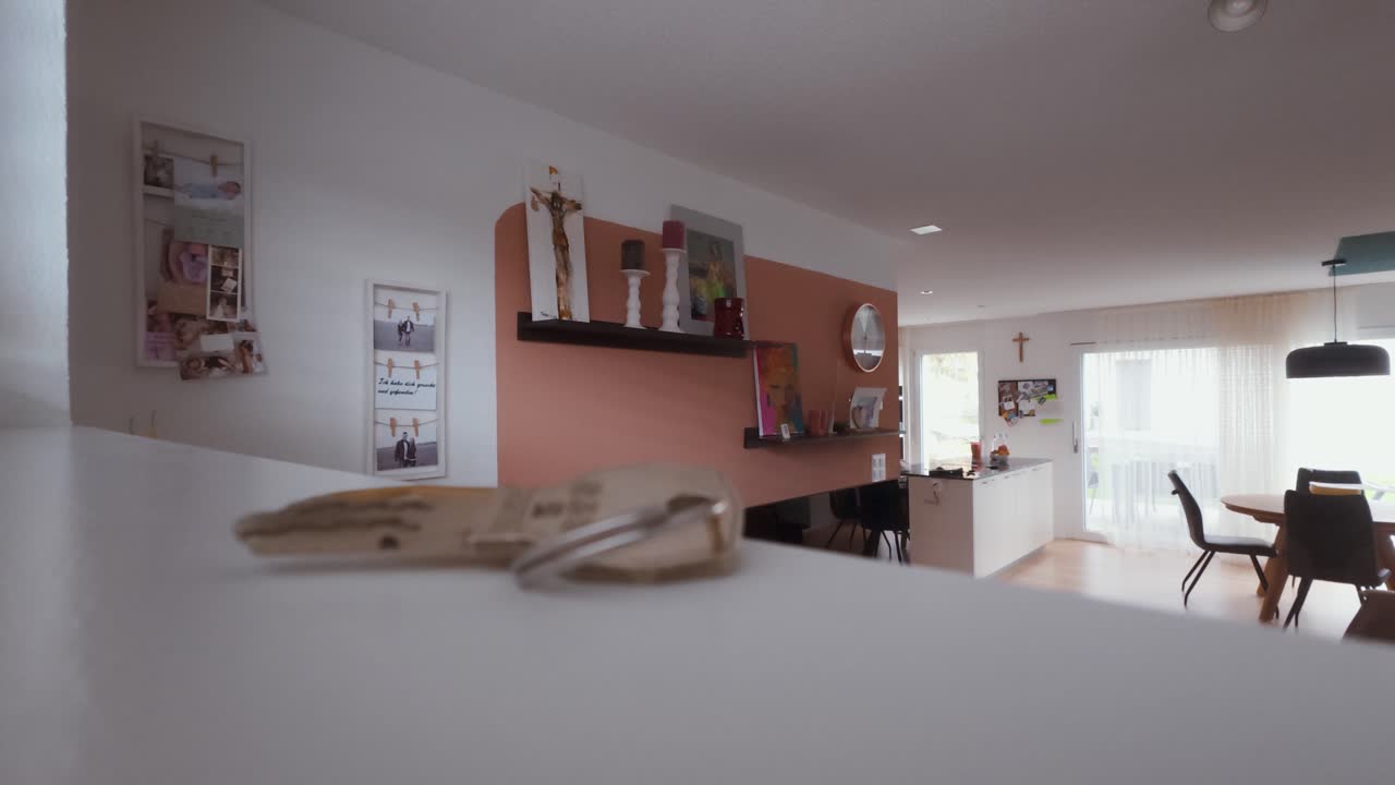 A man places a key on a table, removes his backpack, and walks away. Emotional scene symbolizing farewell, moving out, or ending a relationship — also fitting for Airbnb checkout or departure themes