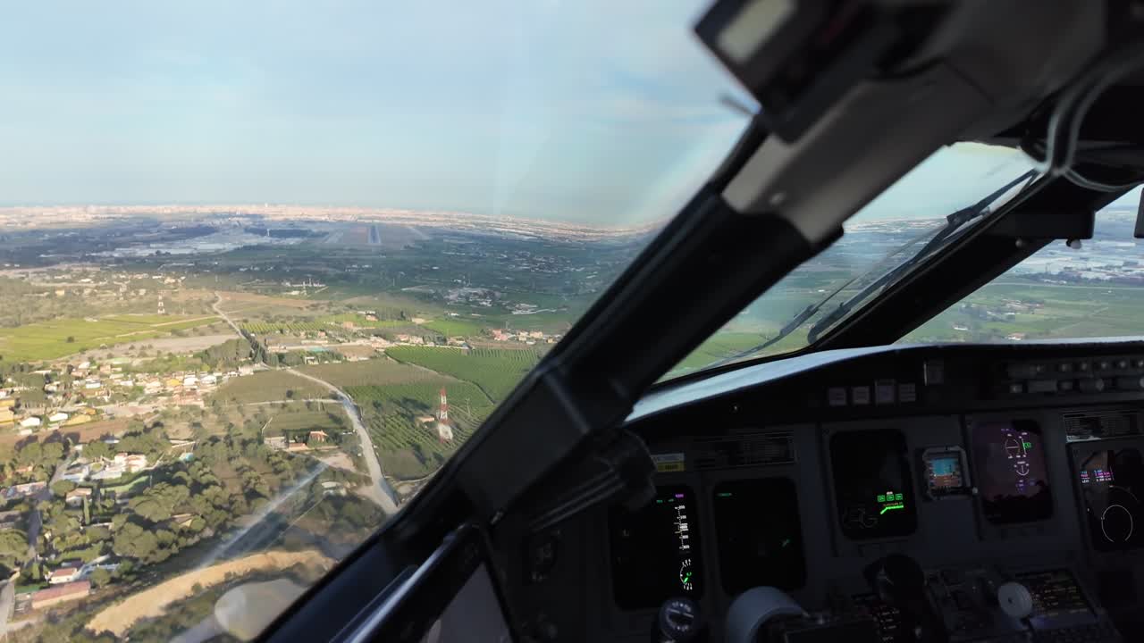 an immersive approach through the pilot’s eyes in a real time flight to Valencia airport, with a view of the runway ahead and the jet shadow on the ground. 4K