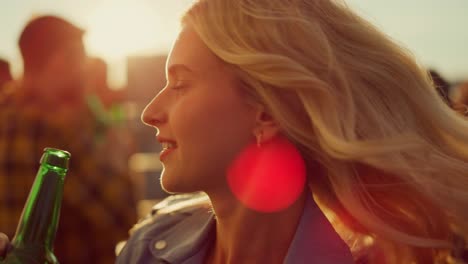 happy woman dancing at rooftop party