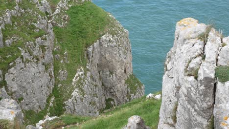 grassy rocky great orme cliff edge mountain edge view looking down to scenic sea view