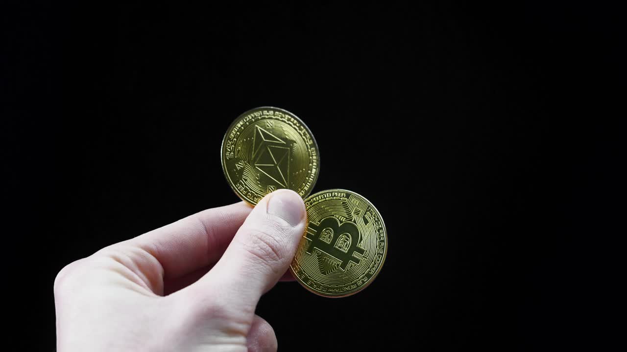 hand holding golden coins etc bitcoin and etc etheruem on black studio background concept of crypto currencies investment trading online