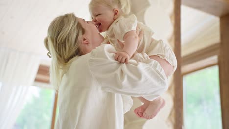 mother and daughter playfully kissing