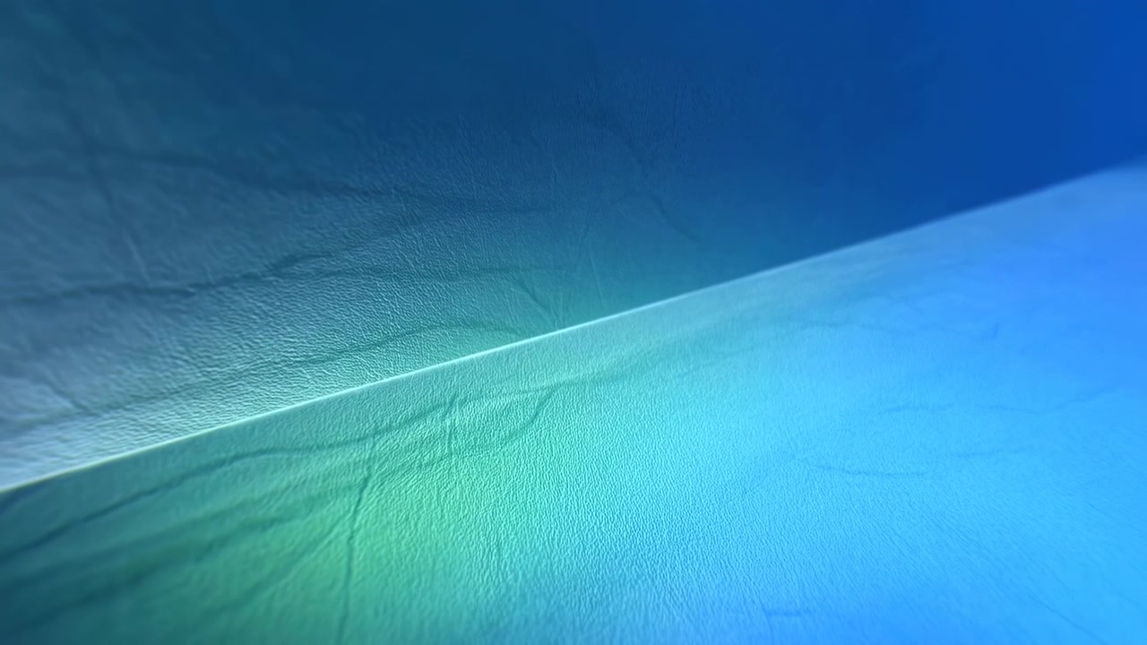 Fine wrinkles and subtle pebbled texture remain visible under cool turquoise light, with a raised diagonal ridge dividing darker blue upper space from a bright cyan foreground.