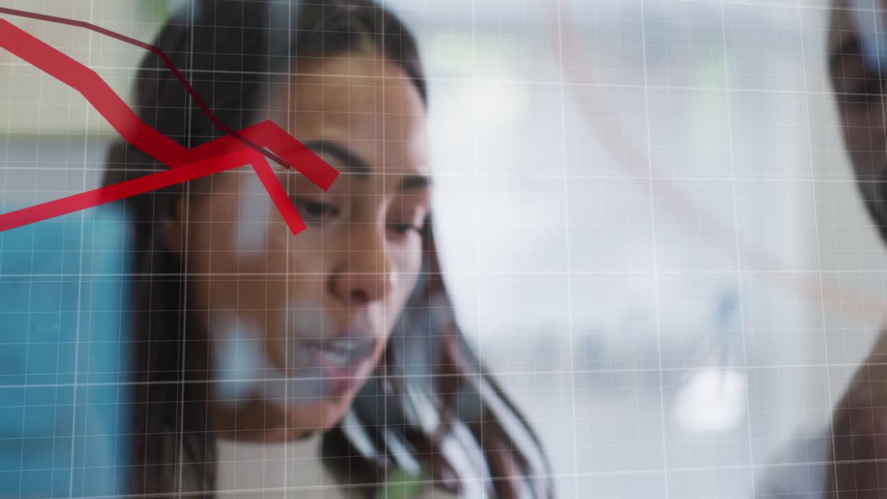 Animation of multiple falling graphs over diverse coworkers discussing and writing on notes